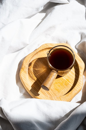 Cozy homely scene with coffee cup in bed. Morning concept.の写真素材