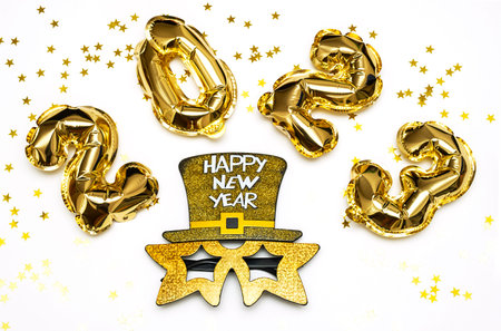 2023 number made from golden balloons and carnival mask. happy new year concept.