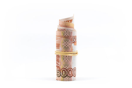 Rolled up five thousand rubles bills on white. Roll of Russian currency.