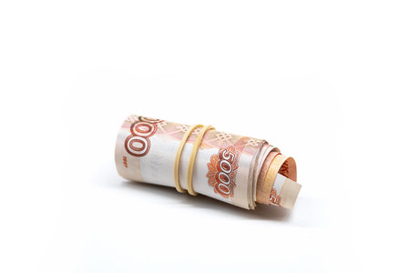 Rolled up five thousand rubles bills on white. Roll of Russian currency.の写真素材