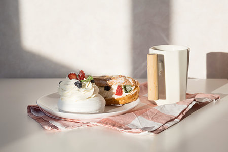 Sweet desserts with strawberry, blueberry and mint on white table. Continental breakfast with coffee...