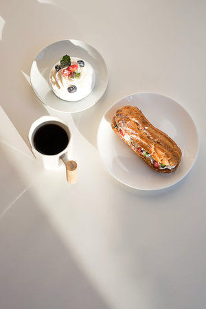 Sweet desserts with strawberry, blueberry and mint on white table. Continental breakfast with coffee...