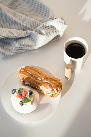 Sweet desserts with strawberry, blueberry and mint on white table. Continental breakfast with coffee...
