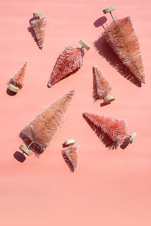 Miniature artificial Christmas trees, bottle brush trees for winter decor. Monochrome Christmas or New Year layout.の写真素材