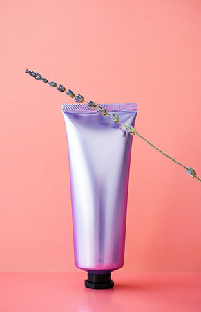 Shined cosmetic tube mock up. Plastic packaging of professional skin care cream and lavender flower.の写真素材