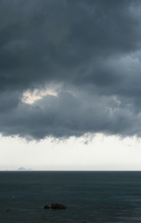Stormy clouds reflecting in the sea. Rainy seascape.の写真素材
