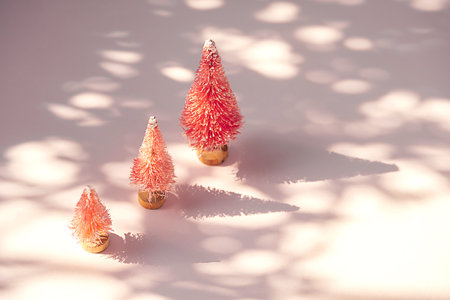 Tiny decorative Christmas trees. Vibrant wintertime background.の写真素材