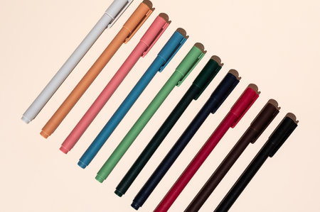 Some colorful pen arranging on beige.の写真素材