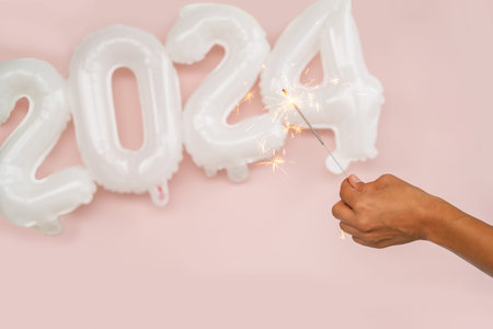 Sparkling candle fire in honor of 2024 New Year.