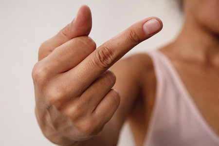 Woman showing middle finger gesture.の写真素材