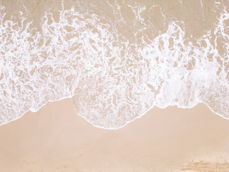 Drone view ocean foam. Transparent clear wave coming on sandy beach aerial shot.の写真素材