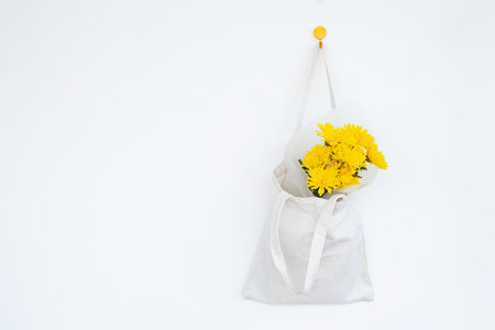Blooms in reusable textile bag. Springtime burst of sunshine.の写真素材