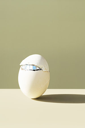 Cracked easter egg. Minimalist creative still life.の写真素材