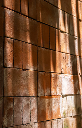 Patterns made from light and shadows on brick wall.