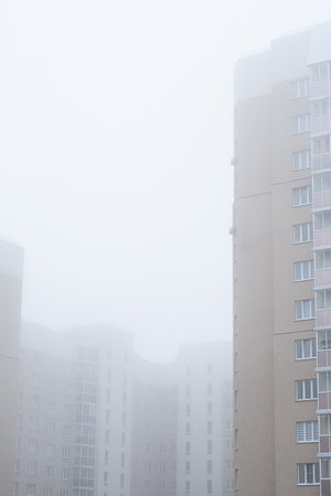 Multistory apartment building during foggy morning.の写真素材
