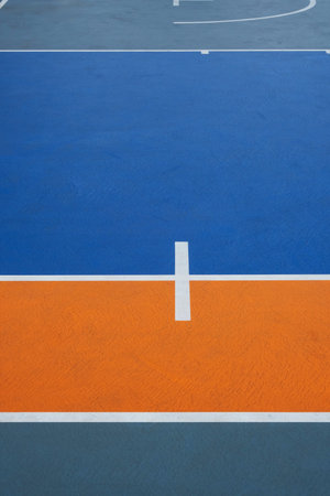 Blue and orange basketball court with white markings. Outdoor sports conceptの写真素材