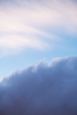 Soft pastel sky with scattered clouds in the morning light.