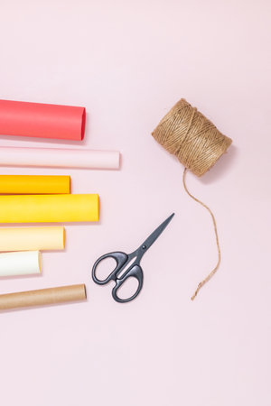 Crafting tools on pastel background with colorful rolls of paper.の写真素材