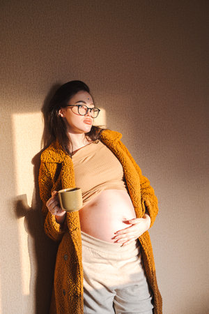 Portrait of pregnant woman with a cup of tea.の写真素材