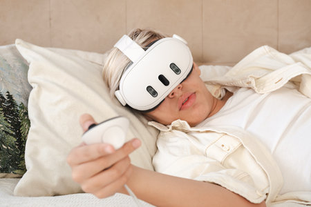 Teenager wearing virtual reality headset at home.の写真素材