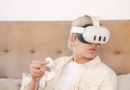 Teenager wearing virtual reality headset at home.の写真素材