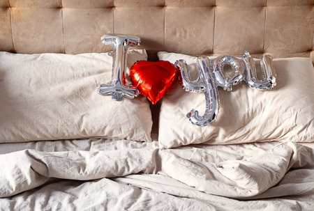"I love you" from balloon on the bed. Valentine's concept.の写真素材