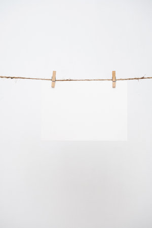 Blank note paper hanging with wooden clips.の写真素材