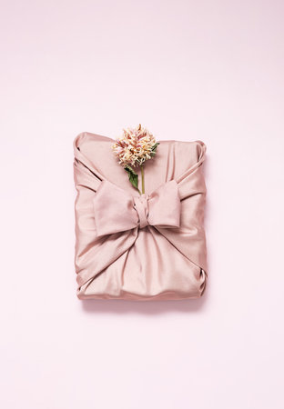 Gift box wrapped in reusable fabric, decorated dried flower.の写真素材