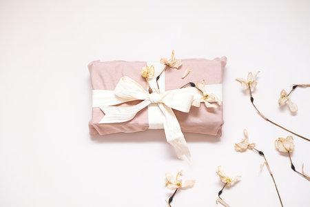 Sustainable cloth wrapped gift decorated dried flowers.の写真素材