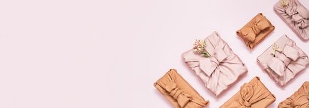 Presents wrapped in fabric scatted on pink.の写真素材