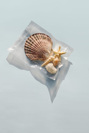 Seashells and starfish in vacuum plastic packing, showcasing of the worlds ocean plastic pollution.