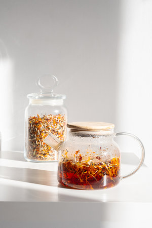 Natural Marigold Herbal Tea in Teapot. Still Life on White.の写真素材