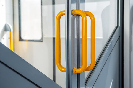 Yellow Handrails on Modern Train Doors for Safety, Commuter Transportation and Public Access.の写真素材