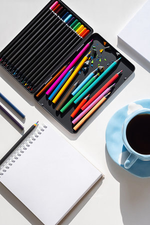 Creative Workspace With Colored Pencils and Blank Artist Block. Art Therapy for Mental and Emotional...