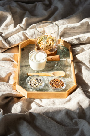 Healthy Morning Meal with Granola and Seeds on Linen Bed. Breakfast Ingredients Concept.の写真素材