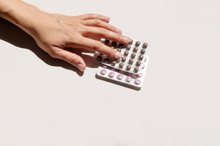 Woman Hand Selecting Contraception Pill Blister Pack. Medical Concept for Reproductive Health and...