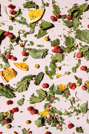 Dried Ingredients for Herbal Tea Scattered on Pink Background. Natural Healthy Drink Components for Wellness.の写真素材