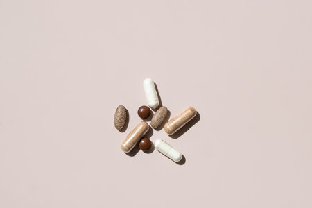 Collection of Various Dietary Supplements and Vitamins Arranged on Light Background. The Capsules are in Different Shapes and Colors.の写真素材