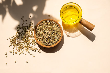 Hemp Seeds in Bowl and Hemp Seed Oil in a Clear Glass Pot. Cannabis Natural Product for Healthy Diet.の写真素材
