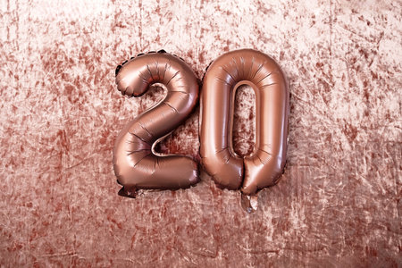 Twenty Number by Balloon on Velvet Fabric Texture. Celebration Background for Birthday or Anniversary Party. Holiday Banner.の写真素材