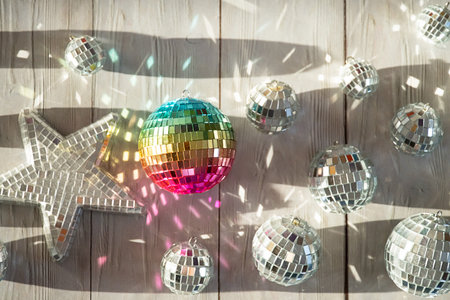 Rainbow disco ball and silver disco balls with light reflections. Party decoration or celebration concept.の写真素材