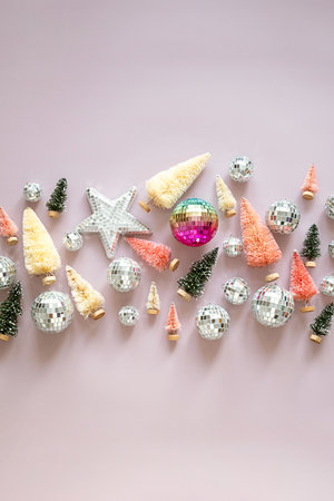 Bottle brush christmas trees, disco ball ornaments and star decoration for holiday celebration.の写真素材