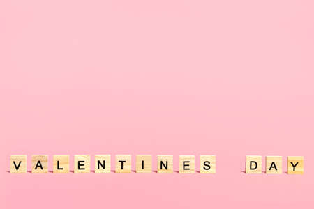 Inscription Valentines Day in wooden letters on a pink backgroundの写真素材