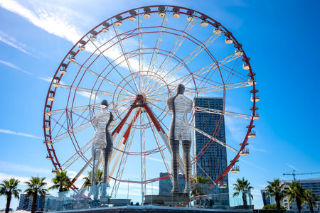 Batumi, Georgia, September 15, 2022: Ali and Nino in love by sculptor Tamara Kvesitadze in front of the Ferris wheel.のeditorial素材