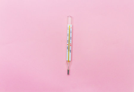 mercury thermometer on a pink backgroundの写真素材