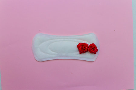 laying on a pink background. Female strip with blood elements. Womens critical days
