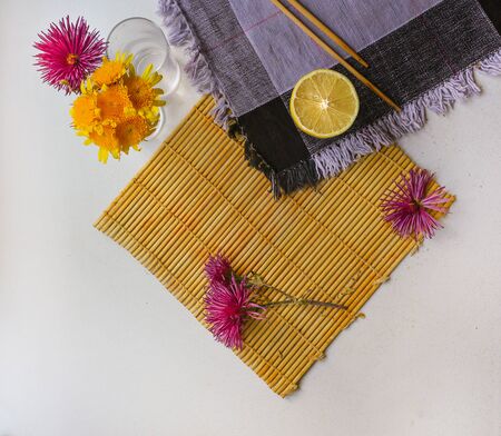 flatlay of a lemon, echinacea on a white surfaceの写真素材