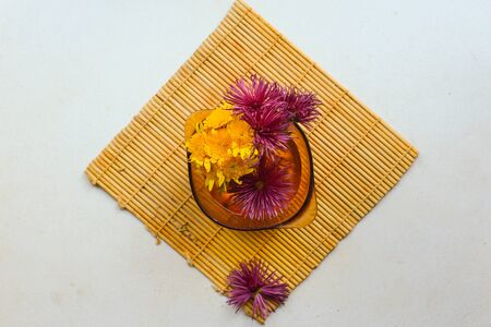 flatlay of a lemon, echinacea on a white surfaceの写真素材