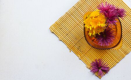 flatlay of a lemon, echinacea on a white surfaceの写真素材