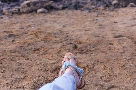 Feet in light sandals on the beach on the background of the Golden Gate Bridgeの写真素材